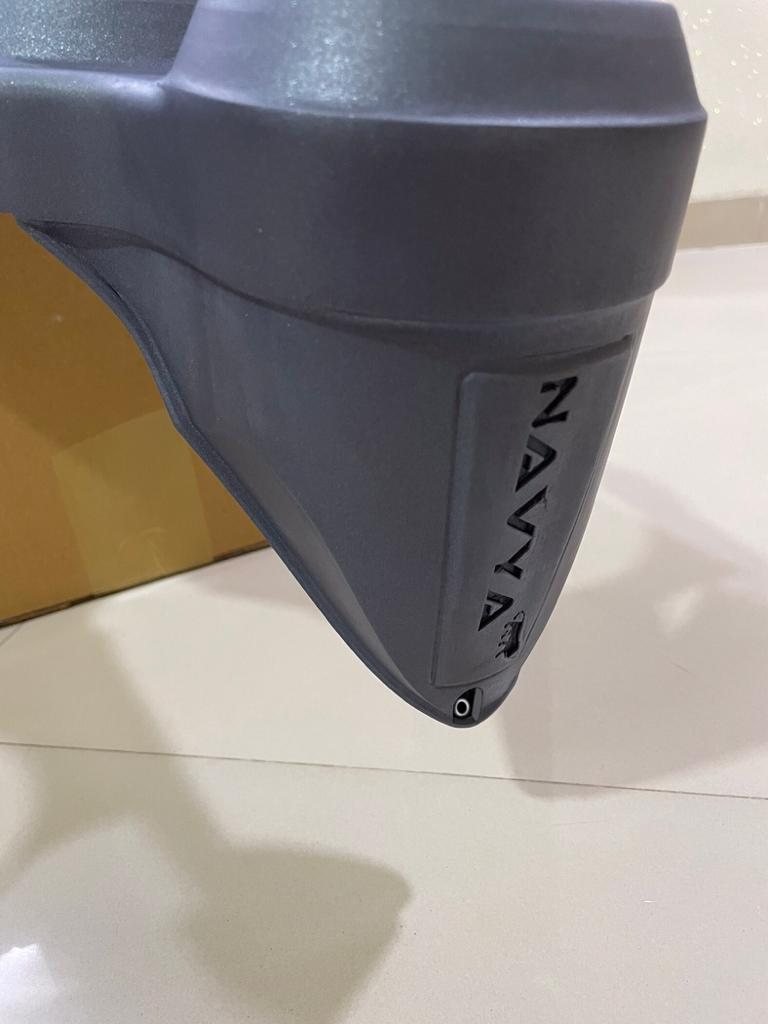 Close-up of the grey housing with NAVYA embossed down its edge